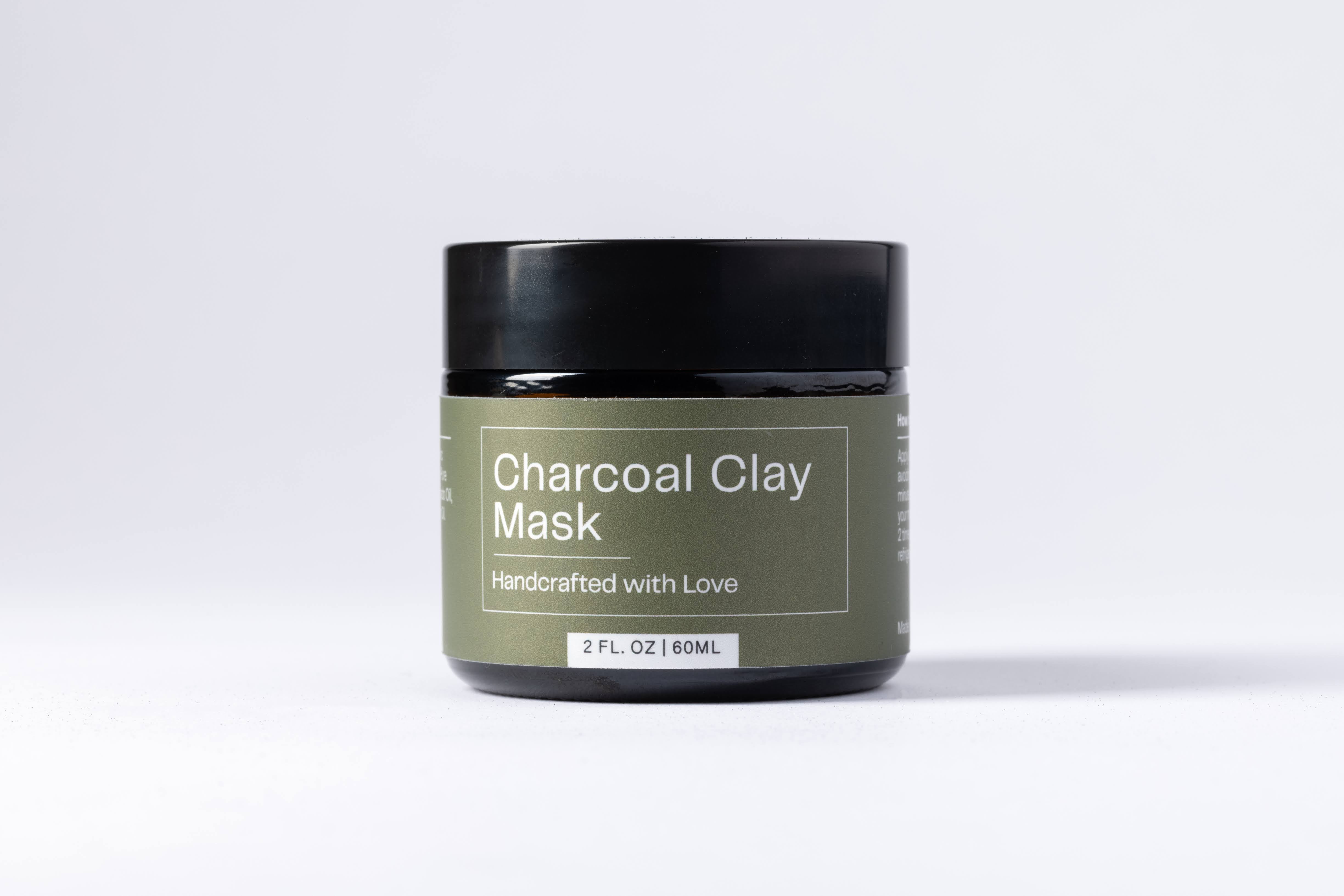 A jar of Charcoal Clay Mask in a white background. Organic skincare, made in Santa Clara, CA.