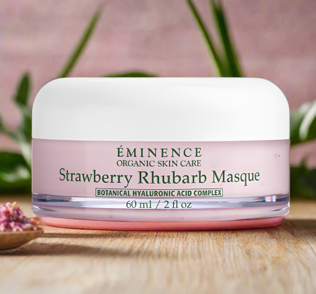 A jar of Eminence's Strawberry Rhubarb Masque on a wooden surface with a natural background